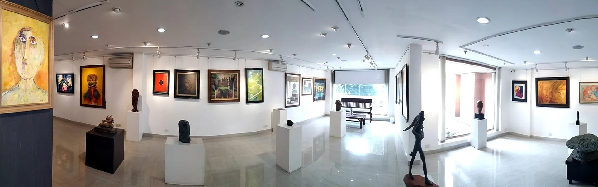 Art gallery interior showcasing original paintings and sculptures at Aakriti Art Gallery