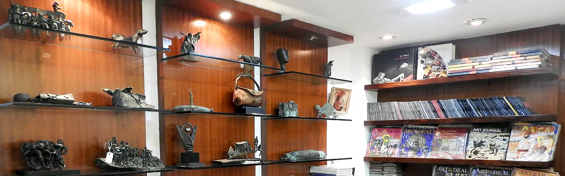 Bronze sculptures and art publications displayed inside Aakriti Art Gallery