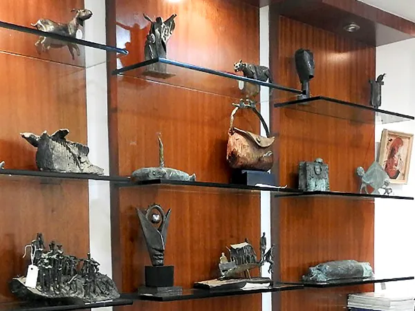 Bronze sculptures and art publications displayed inside Aakriti Art Gallery